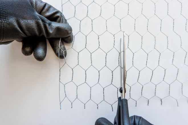 cutting-chicken-wire-with-scissors