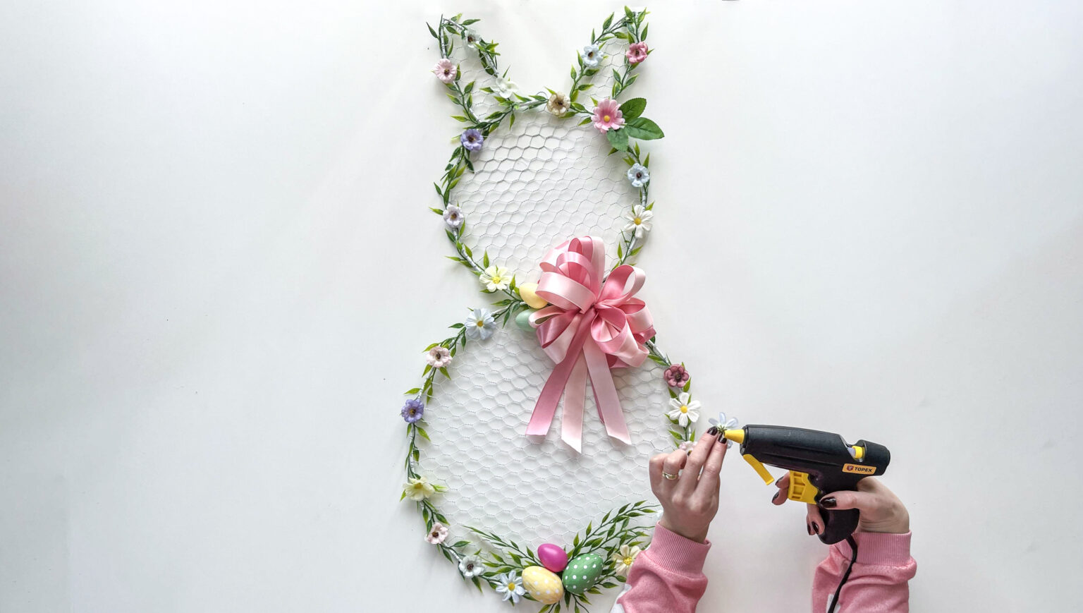 adding-flower-decors-to-bunny-wreath